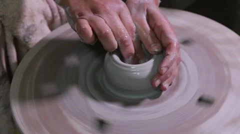 Hands of a potter, creating an earthen jar on the circle Stock Footage 61920295