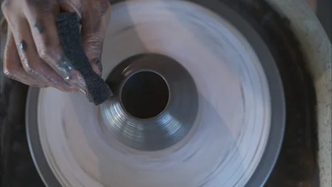 Hands of a potter, creating an earthen jar on the pottery wheel Stock Footage 260314116