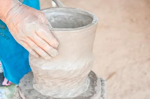 Hands of a potter, creating an earthen jar on the circle Stock Photos