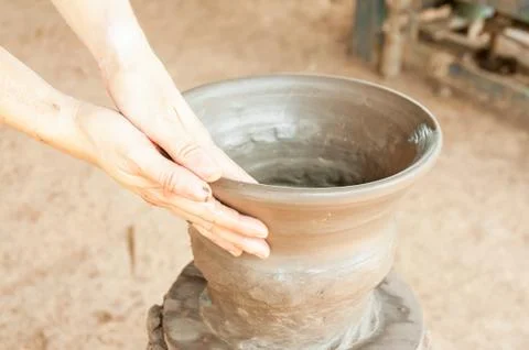 Hands of a potter, creating an earthen jar on the circle Stock Photos
