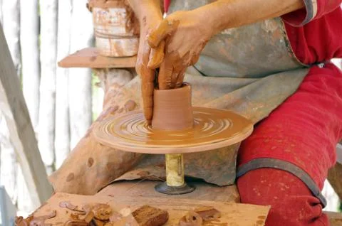Hands of a potter, creating an earthen jar on the circle Stock Photos
