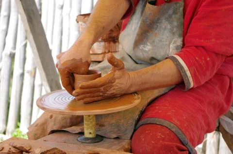 Hands of a potter, creating an earthen jar on the circle Stock Photos