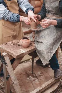 The hands of potter help make  pitcher on  pottery wheel Stock Photos