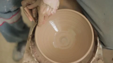 Hands of a potter. Potter making ceramic pot on the pottery wheel. workshop, 動画素材 87495984