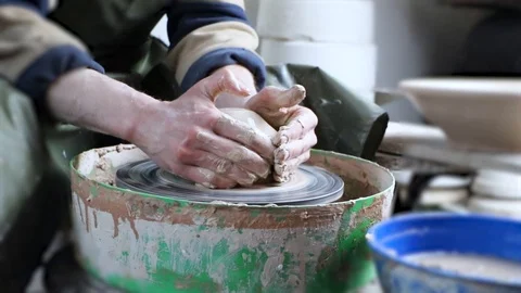 Hands of a potter on a pottery wheel close-up. Old traditional art, handmade, cl Stock-Footage 124490463