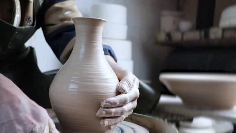 Hands of a potter on a pottery wheel close-up. Old traditional art, handmade, cl Stock-Footage 124490491