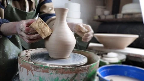 Hands of a potter on a pottery wheel close-up. Old traditional art, handmade, cl Stock-Footage 124490523