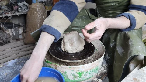 Hands of a potter on a pottery wheel close-up. Old traditional art, handmade, cl Stock-Footage 124490536
