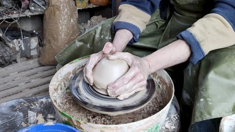 Hands of a potter on a pottery wheel close-up. Old traditional art, handmade, cl Video stock 124490720