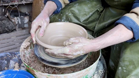 Hands of a potter on a pottery wheel close-up. Old traditional art, handmade, cl Stock-Footage 124490769