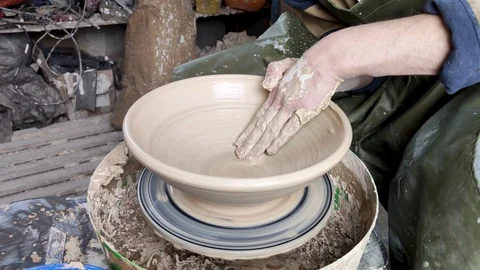 Hands of a potter on a pottery wheel close-up. Old traditional art, handmade, cl Stock-Footage 124490818