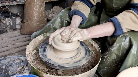 Hands of a potter on a pottery wheel close-up. Old traditional art, handmade, cl Stock-Footage 124490862