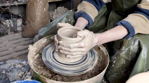 Hands of a potter on a pottery wheel close-up. Old traditional art, handmade, cl Stock-Footage 124490880