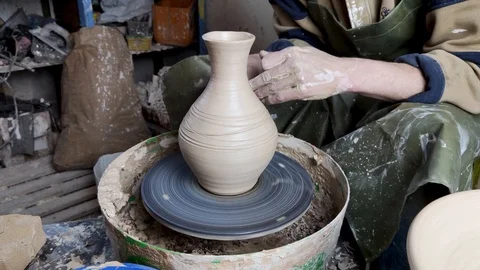 Hands of a potter on a pottery wheel close-up. Old traditional art, handmade, cl Stock-Footage 124490899