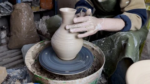 Hands of a potter on a pottery wheel close-up. Old traditional art, handmade, cl Stock-Footage 124490921