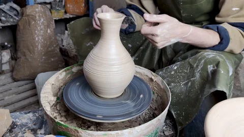 Hands of a potter on a pottery wheel close-up. Old traditional art, handmade, cl Stock-Footage 124490935