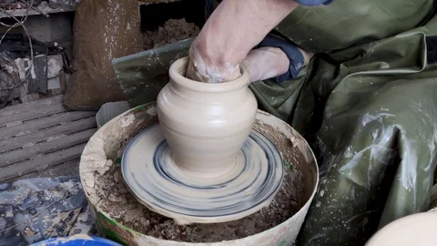 Hands of a potter on a pottery wheel close-up. Old traditional art, handmade, cl Stock-Footage 124490960