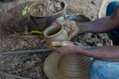 Hands of a potter at work. Potter making ceramic mug on the pottery wheel 写真素材