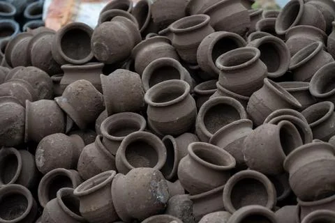 Hands of a potter at work. Potter making ceramic mug on the pottery wheel Stock Photos