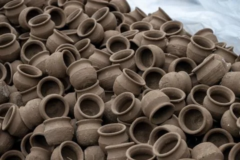 Hands of a potter at work. Potter making ceramic mug on the pottery wheel Stock Photos