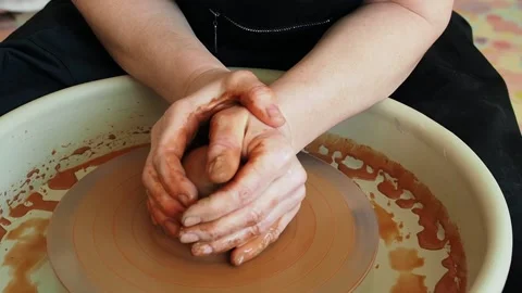 The hands of a pottery master work with red raw clay Stock-Footage 235758946