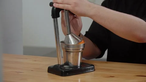Hands pouring freshly squeezed orange juice into a glass glass 스톡 동영상 241994336