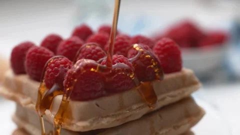 Hands Pouring Maple Syrup Onto a Stack Of Pancakes With fresh berries. Stock-Footage 336589057