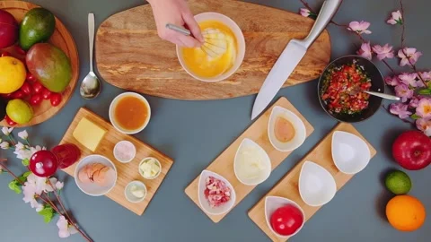 Hands Pouring Milk into Egg Mixture on Kitchen Table Overhead Stockbeeldmateriaal 342836118