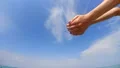 The hands pouring the sand in the sea. slow motion HD Footage