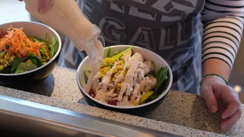 Hands Pouring Sauce into a Fresh Caesar Salad Stock Footage 322624632