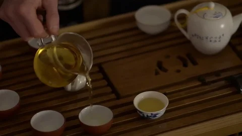Hands pouring tee, chinese tea ceremony, closeup shoot Stock Footage 75689638