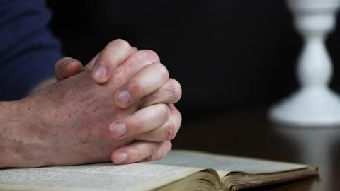 Hands praying on the Bible Stock Footage 142274223