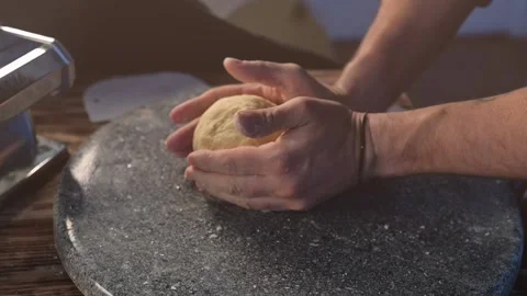 Hands prepare the dough. Chef preparing homemade pasta dough in slow motion. Stock Footage 134057430
