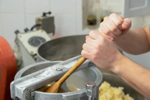 Hands preparing and kneading gnocchi with machine Stock Photos