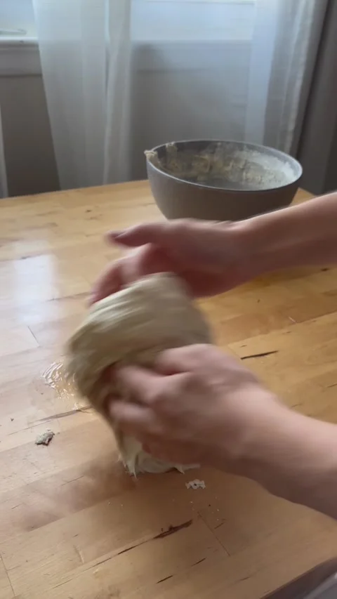 Hands preparing bread dough on wooden table. Stock Footage 292341798