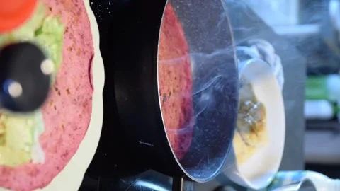 Hands Preparing Chicken and Lettuce Piadina While Flatbread Warms in Frying Pan Stock Footage 341517621