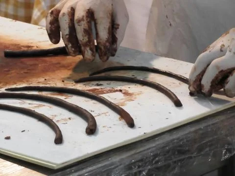 Hands preparing chocolate decoration on a worktop Stock Photos