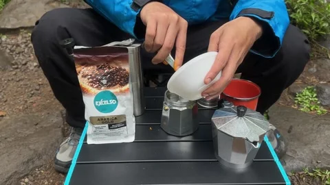 Hands Preparing Coffee Grounds for Moka Pot, Outdoor Camping, Close-Up Stock Footage 324850715