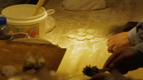 Hands Preparing Dough and Dumplings on Floured Table in Beijing Kitchen, China Stock Footage 345745523