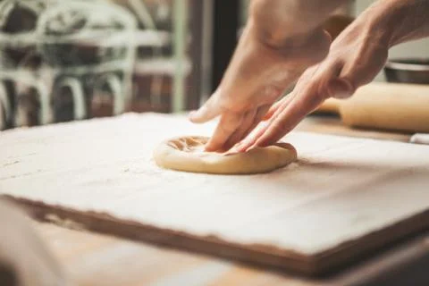 Hands preparing dough basis for pizza Stock Photos