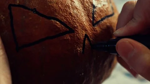 Hands preparing a Halloween pumpkin. Stock Footage 234236906