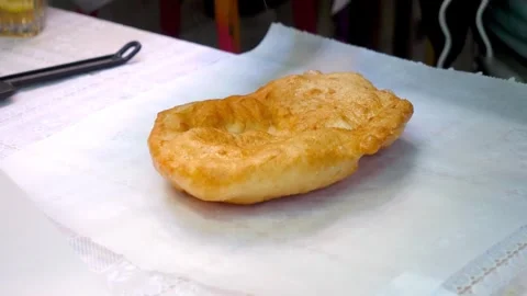 Hands preparing Krumplis Langos with sour cream and cheese Stock Footage 320056699