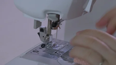 Hands preparing a peach fabric for sewing Stock Footage 87359586