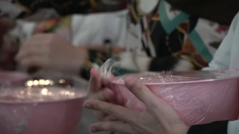 Hands Preparing Pink Plastic Bowls Stock Footage 317472535