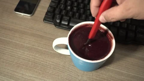 Hands preparing a purple juice in a blue cup. Brazilian food called Açai. Stock Footage 139665355