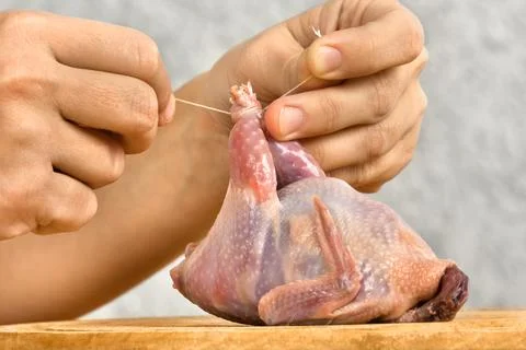 Hands preparing quail for roasting Stock Photos