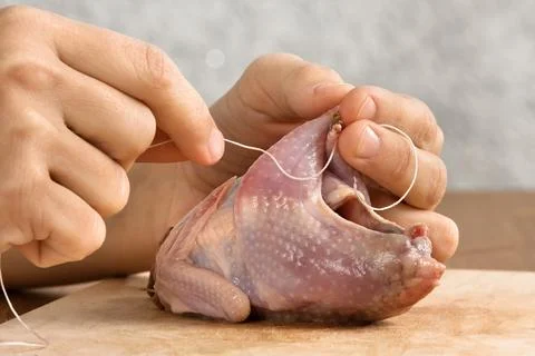 Hands preparing quails before cooking Stock Photos