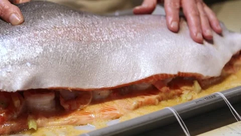 Hands Preparing Salmon and Shrimp Dish on Baking Tray in Kitchen Stock Footage 298164647