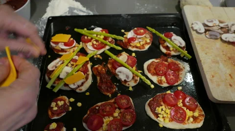 Hands preparing small pizzas with cheese Stock Footage 56803119