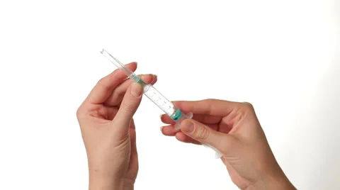 Hands Preparing Syringe on white background Stock-Footage 27121293